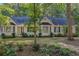 Charming ranch home with beautiful landscaping, blue shutters, and a welcoming entrance at 360 N Oakland Circle, Mcdonough, GA 30253