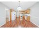 Eat-in kitchen with wood cabinets, white appliances, and wood-look flooring at 360 N Oakland Circle, Mcdonough, GA 30253