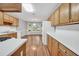 Well-lit kitchen featuring wood cabinets, laminate countertops, and views to the dining area at 360 N Oakland Circle, Mcdonough, GA 30253