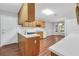 Well-lit kitchen featuring wood cabinets, laminate countertops, and views to the dining area at 360 N Oakland Circle, Mcdonough, GA 30253