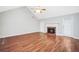Large living room showcasing a brick fireplace and hardwood flooring at 360 N Oakland Circle, Mcdonough, GA 30253