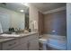 Bathroom with granite countertops, a tub, and neutral tiled surround at 860 Peachtree Ne St # 1613, Atlanta, GA 30308