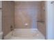 Bathroom with a bathtub, tiled surround, and tiled floors at 860 Peachtree Ne St # 1613, Atlanta, GA 30308