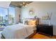 Bedroom with a city view, large windows, hardwood floors, and contemporary decor at 860 Peachtree Ne St # 1613, Atlanta, GA 30308