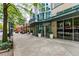 Commercial building entrance with sidewalk, landscaping, and retail spaces at 860 Peachtree Ne St # 1613, Atlanta, GA 30308