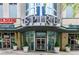 Condominium building entrance with architectural details and nearby businesses at 860 Peachtree Ne St # 1613, Atlanta, GA 30308