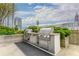 Outdoor grilling area with stainless steel grills and cityscape views at 860 Peachtree Ne St # 1613, Atlanta, GA 30308