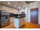 Well-lit kitchen featuring a central island, stainless steel appliances, and modern fixtures at 860 Peachtree Ne St # 1613, Atlanta, GA 30308