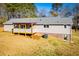 The home features an expansive yard, covered deck, roof, and siding on the back exterior, offering a private retreat at 280 Hitchcock Rd, Dallas, GA 30157