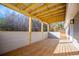 Covered back porch boasts wood floors, wood beams, and recessed lighting for a great outdoor living space at 280 Hitchcock Rd, Dallas, GA 30157