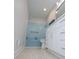 Updated bathroom boasts blue tile, shower head and white cabinets at 280 Hitchcock Rd, Dallas, GA 30157