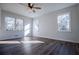 Bedroom filled with natural light features three windows, ceiling fan and new wood flooring at 280 Hitchcock Rd, Dallas, GA 30157