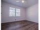 An empty bedroom features hardwood floors, ceiling fan and large windows at 280 Hitchcock Rd, Dallas, GA 30157