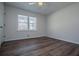 Bedroom features hardwood floors, a ceiling fan, and large windows at 280 Hitchcock Rd, Dallas, GA 30157