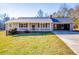 Charming single-story home featuring a covered porch, attached garage, and a well-maintained front yard at 280 Hitchcock Rd, Dallas, GA 30157