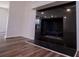 Close up of a black fireplace with light walls and hardwood floors at 280 Hitchcock Rd, Dallas, GA 30157
