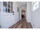 Hallway with white paneled walls leads to an open kitchen and entryway with bright doors at 280 Hitchcock Rd, Dallas, GA 30157