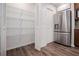 Pantry and fridge with stainless steel appliances and wood floor at 280 Hitchcock Rd, Dallas, GA 30157