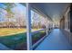 Covered front porch featuring white columns, painted floor, and woodland views at 280 Hitchcock Rd, Dallas, GA 30157