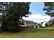Expansive backyard with mature trees surrounding a well-maintained lawn at 3109 Windgate Dr, Buford, GA 30519
