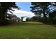 Large backyard featuring a spacious lawn and mature trees providing privacy at 3109 Windgate Dr, Buford, GA 30519