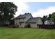 Lush backyard featuring a deck, large lawn, and mature trees at 3109 Windgate Dr, Buford, GA 30519