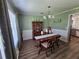 Traditional dining room with decorative molding, wood floors, and an elegant chandelier at 3109 Windgate Dr, Buford, GA 30519