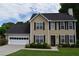 Traditional home with a well-maintained lawn, dark shutters and a two-car garage offering curb appeal at 3109 Windgate Dr, Buford, GA 30519