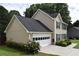 Attractive two-story home with a two-car garage and a well-kept lawn in a leafy neighborhood at 3109 Windgate Dr, Buford, GA 30519