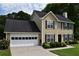 Charming two-story home with a two-car garage and manicured landscaping in a suburban neighborhood at 3109 Windgate Dr, Buford, GA 30519