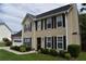 View of a classic two-story house featuring tidy landscaping, neutral siding, and an attached two car garage at 3109 Windgate Dr, Buford, GA 30519