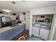 Bright kitchen with stainless steel appliances, countertop space, and pantry, along with convenient laundry access at 3109 Windgate Dr, Buford, GA 30519