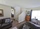 Comfortable living room with neutral walls, wood floors, and stairway at 3109 Windgate Dr, Buford, GA 30519