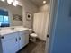 Spotless bathroom features a sleek vanity, framed mirror, and a pristine shower with white curtain, for a refreshed look at 3615 Hawthorne Terrace, Atlanta, GA 30337
