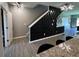 Staircase with modern wood accent wall paneling, wood floors, and updated lighting fixtures at 3615 Hawthorne Terrace, Atlanta, GA 30337