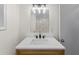 Stylish bathroom featuring modern vanity with sleek faucet and a well-lit mirror at 466 Thackery Sw Pl, Atlanta, GA 30311