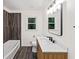 Modern bathroom with wood accent wall, floating vanity, and sleek fixtures at 466 Thackery Sw Pl, Atlanta, GA 30311