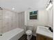 Modern bathroom featuring sleek fixtures and a shower-tub combination at 466 Thackery Sw Pl, Atlanta, GA 30311