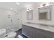 Stylish bathroom with a glass-enclosed shower, dual sink vanity, and modern fixtures at 466 Thackery Sw Pl, Atlanta, GA 30311