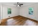 Comfortable bedroom featuring gleaming hardwood floors and ample natural light at 466 Thackery Sw Pl, Atlanta, GA 30311