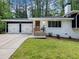 Charming home featuring a stained wooden front door and a two-car garage at 466 Thackery Sw Pl, Atlanta, GA 30311
