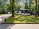 Charming two-story home with well-manicured lawn and mature trees at 466 Thackery Sw Pl, Atlanta, GA 30311