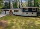 Inviting home with a lush front lawn, mature trees, and a welcoming facade at 466 Thackery Sw Pl, Atlanta, GA 30311
