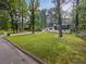 Charming home with a lush green lawn and mature trees at 466 Thackery Sw Pl, Atlanta, GA 30311
