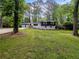Charming home featuring a two-car garage, manicured lawn, and mature trees at 466 Thackery Sw Pl, Atlanta, GA 30311