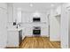 Kitchen features white cabinets, stainless steel appliances, and hardwood floors at 466 Thackery Sw Pl, Atlanta, GA 30311
