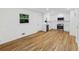 Bright kitchen and living area with white cabinets, stainless steel appliances, and hardwood floors at 466 Thackery Sw Pl, Atlanta, GA 30311