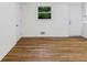 Well-lit living room with hardwood floors and view to exterior at 466 Thackery Sw Pl, Atlanta, GA 30311