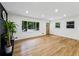 Living room featuring hardwood floors, natural light, a fireplace, and exterior view at 466 Thackery Sw Pl, Atlanta, GA 30311