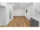 Open living area with hardwood floors, white trim, and access to updated kitchen at 466 Thackery Sw Pl, Atlanta, GA 30311